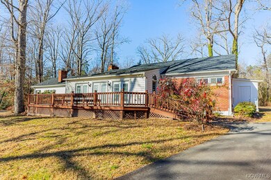 Sunroom and large deck compliment rear of home.