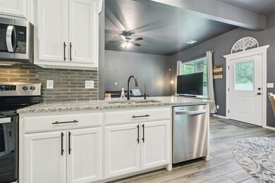 Kitchen featuring light wood-style flooring, a sin