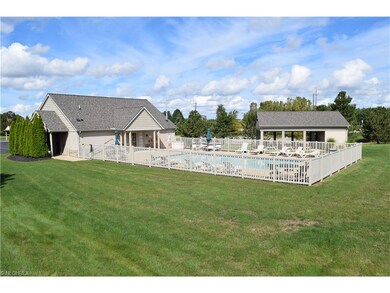Back of club house with pool and picnic shelter.