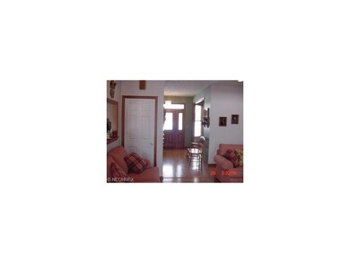 Great Room view to Foyer both with hardwood floors