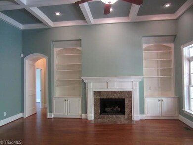 Great Room.  Magnificent proportions, 12' coffered ceiling allows for a very tall Christmas tree!  Custom book shelves grace both sides of the fireplace which has gas logs and a marble surround and beautiful mantel piece.  French doors and windows let in plenty of light and invite one to enjoy the covered back porch and the deck area which is a perfect spot for your grill and outdoor entertaining.