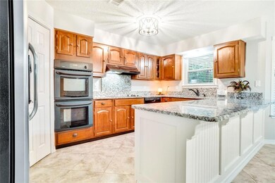 Additional view of kitchen with modern light fixtu