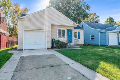 View of front of house with a garage and a front yard