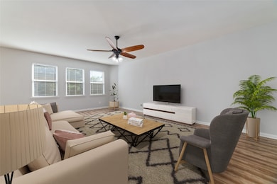 Spacious living room opens to the dining room & kitchen. Tons of natural lighting with the wall of windows overlooking the backyard. Virtually staged.