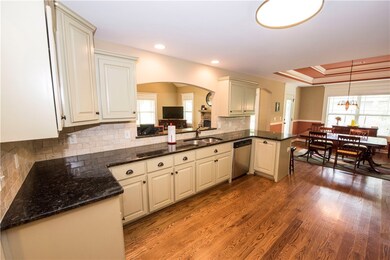 Kitchen with granite counters, pained cabinetry an