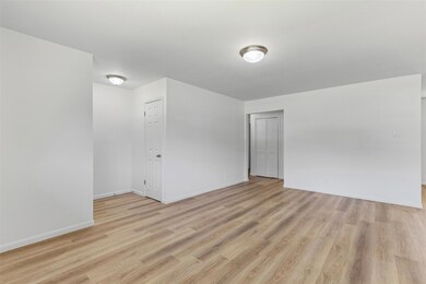 Spare room with baseboards and light wood-style fl