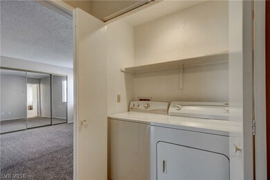 Washer & dryer located next to master bedroom in c