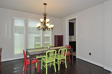 Wood flooring and bright windows continue into the formal dining area.