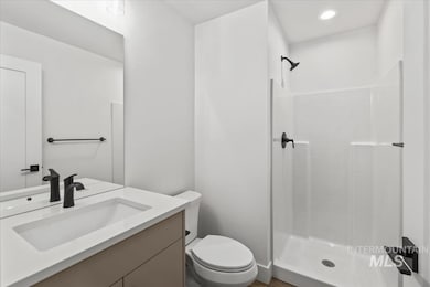 Bathroom featuring vanity, a stall shower, and recessed lighting