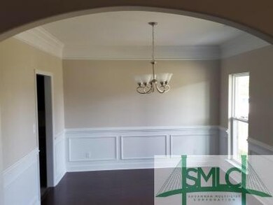 Dining room with wainscoting and crown molding