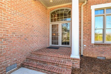 Double front doors and large transom window let in lots of natural light.