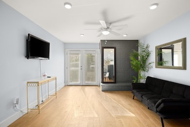 Living area featuring wood finished floors, ceili