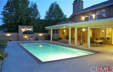 Pool withe the outdoor wood burning fireplace in t