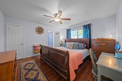 Privately located primary bedroom offers laminate flooring & a large walk-in closet.