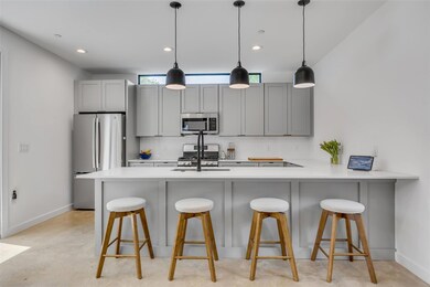 Kitchen featuring stainless steel appliances, tas