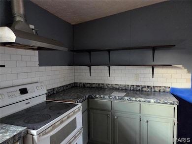 Kitchen featuring open shelves, range with two ovens, range hood, backsplash, and a textured ceiling