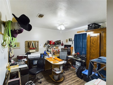 Office space featuring wood finished floors, crown