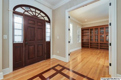 Beautiful hardwood floors with custom inlay adorn the foyer and entry hall.
