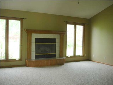 Side windows flanking the fireplace in the Great R