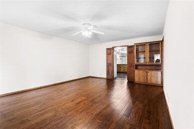 Unfurnished living room featuring dark hardwood / 