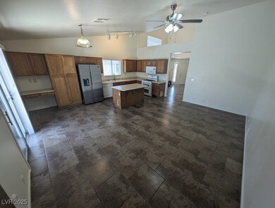 Kitchen featuring stone tile flooring, ceiling fan