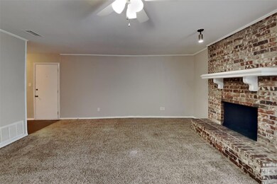 Unfurnished living room featuring a brick fireplac