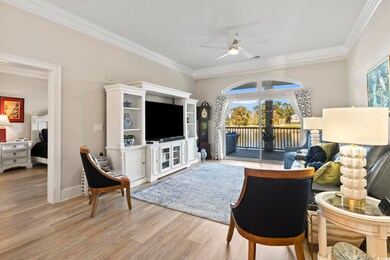 Living room with ornamental molding, light hardwoo
