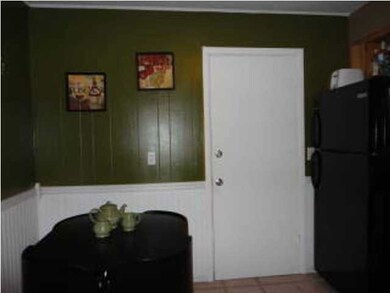 Eating space in kitchen. Door is to the garage.