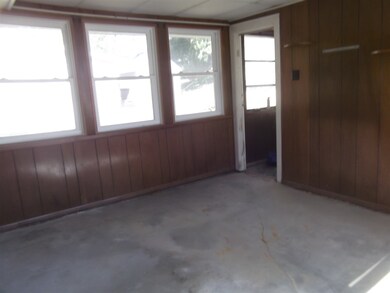 This rear enclosed porch could be a nice den or st