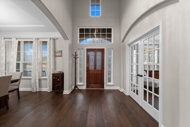 This entryway features a grand front door with gla