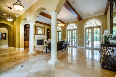 Living Room off the Gallery has Fireplace and cust