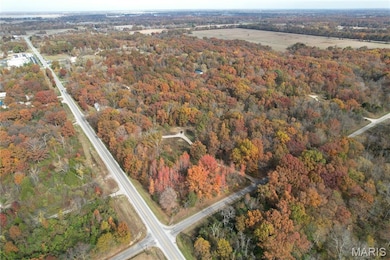 Aerial overview of property's location featuring a heavily wooded area