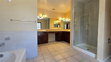 Bathroom featuring vanity, visible vents, a shower