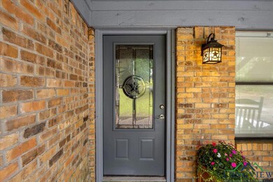 Doorway to property with brick siding