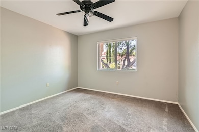 Empty room featuring carpet and ceiling fan