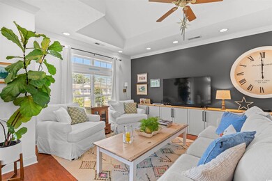 Living room featuring recessed lighting, light wood finished floors, ceiling fan, and ornamental molding