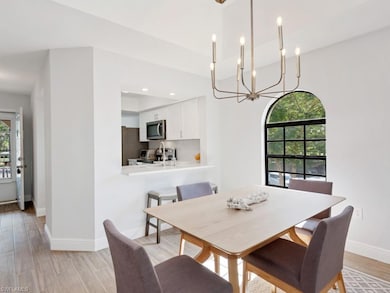 Dining area with a chandelier and light hardwood /