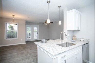 Kitchen featuring white cabinets, sink, stainless 