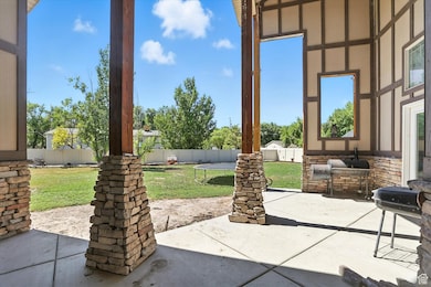 Fenced backyard featuring a patio area, a trampoline, and area for grilling
