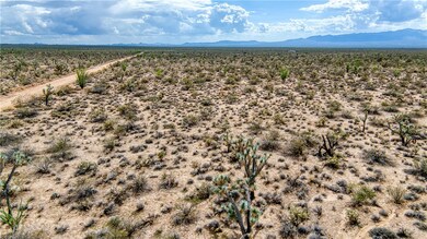 Aerial view of sparsely populated area with a mountain backdrop and a desert landscape