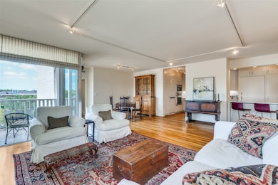 Living area with track lighting and light wood-type flooring