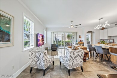 Living room featuring crown molding, light tile pa