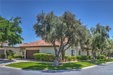 view of property with stucco siding, a tiled roof,