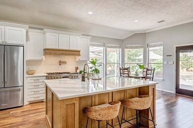 This kitchen is a cook's dream! Beautiful white and stained cabinetry is wrapped in a stunning quartz countertop.