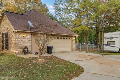 View of home's exterior featuring brick siding, a shingled roof, concrete driveway, and a garage