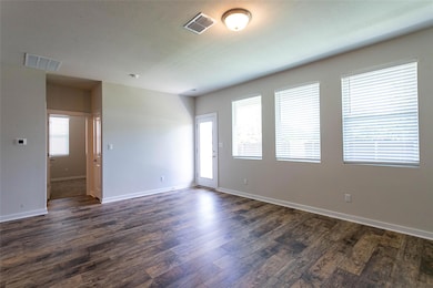 Spare room with dark wood-type flooring and baseb