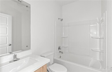 Full bathroom with toilet, shower / bath combination, and vanity