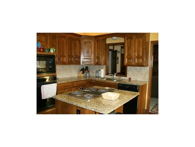 Over-sized granite island with snack bar eating sp