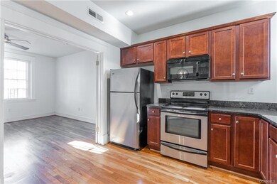 Big kitchen with stainless appliances and granite counters.