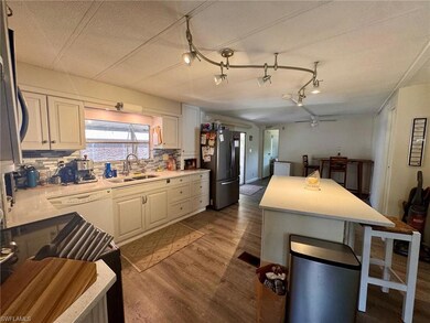 Kitchen featuring freestanding refrigerator, a sin